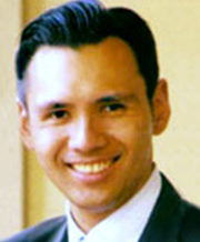 Smiling man in formal attire.