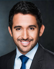 Professional headshot of a smiling man in a suit and tie. Professional headshot of a smiling man in a suit and tie.