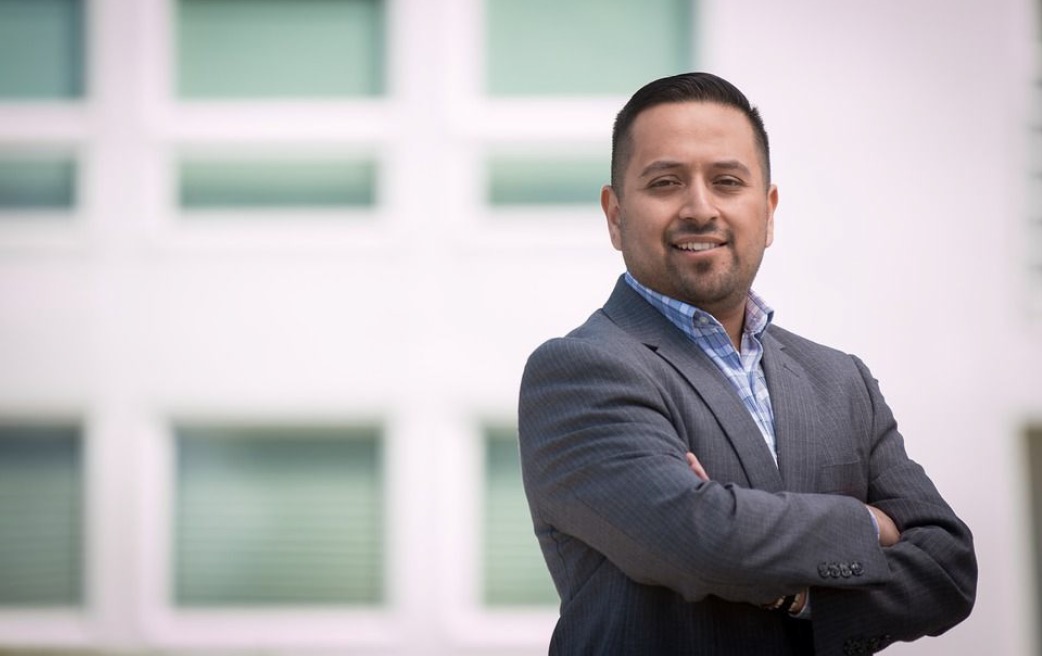Confident man in suit with crossed arms.