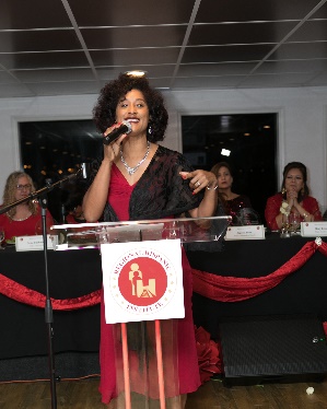 Woman speaking at an event podium.